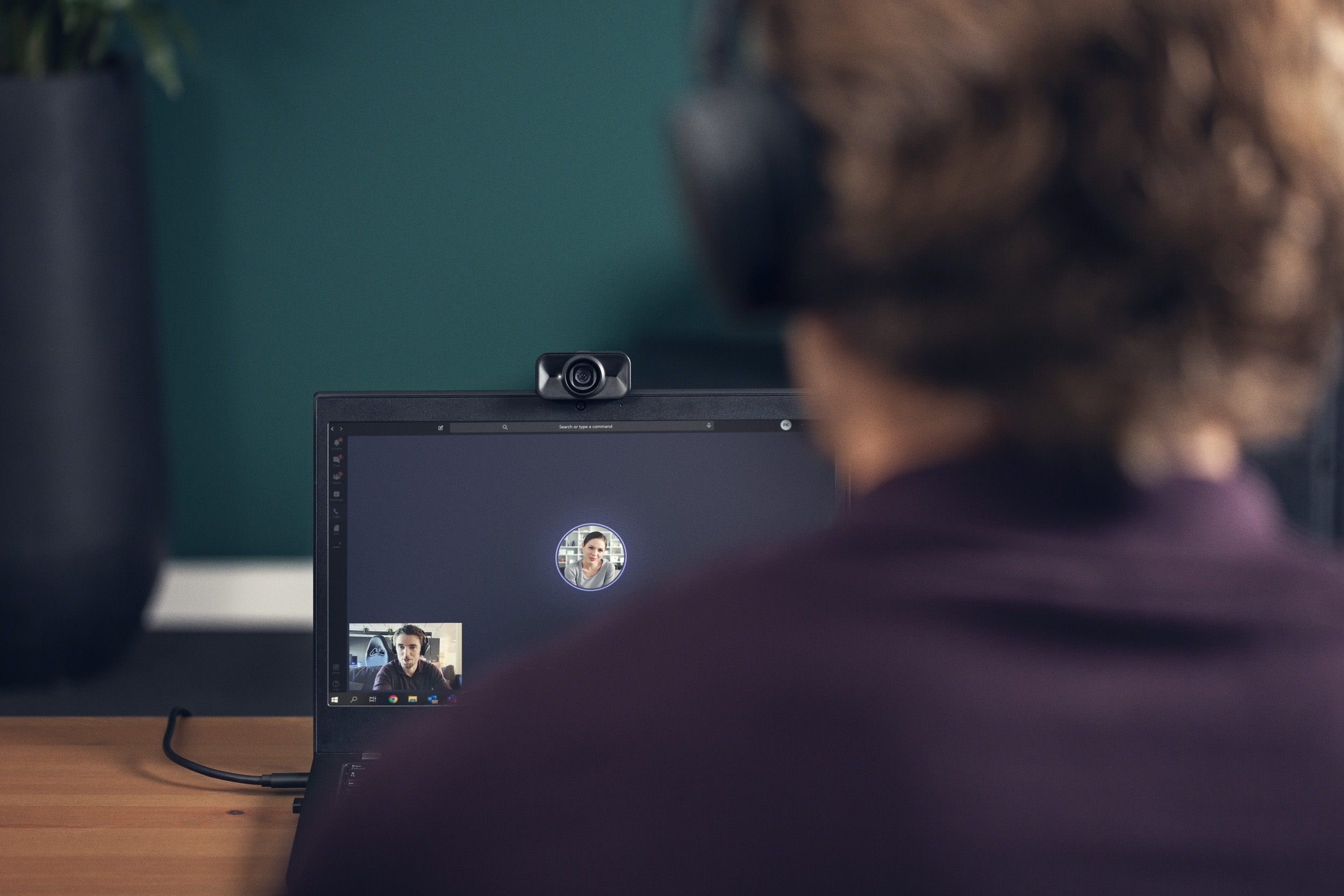 A woman talking to a virtual meeting on her laptop.