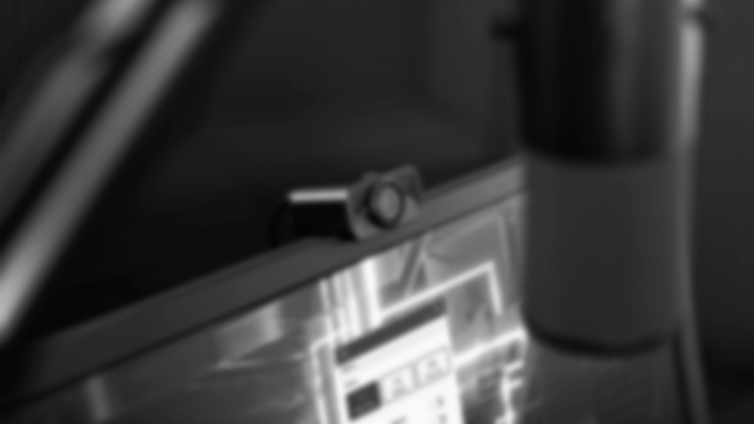 The S6 webcam on top of a computer monitor with a microphone in front of it.