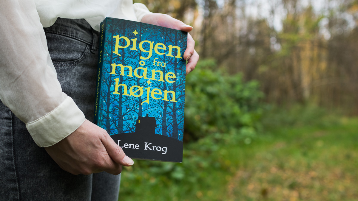 A book being held by a woman's hands.