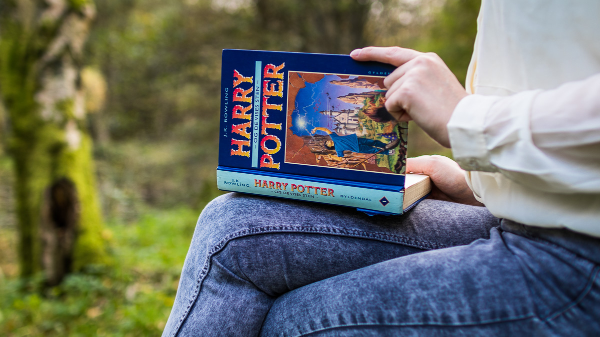 A book sitting on a woman's legs.