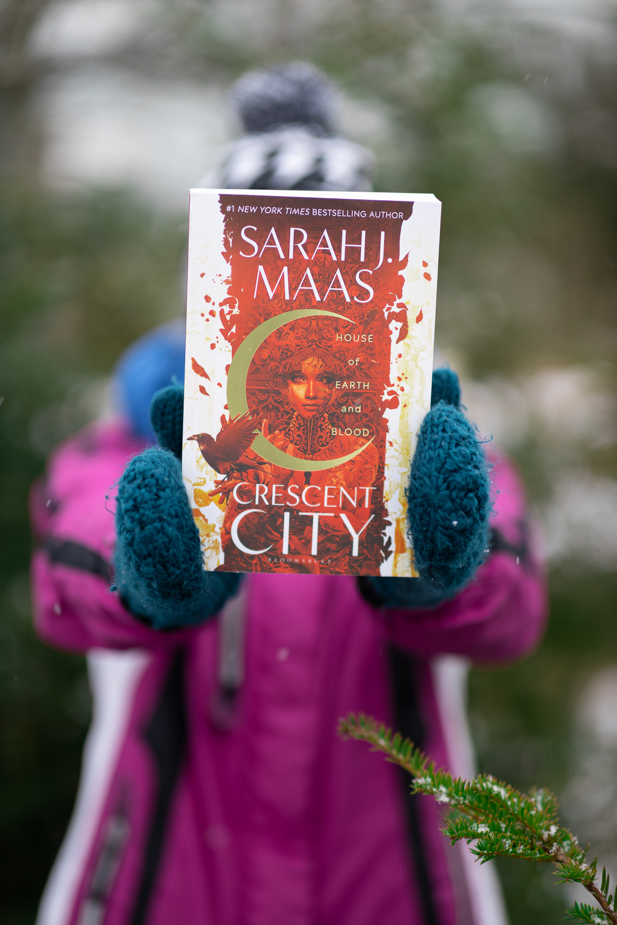 A book being held in front of a woman.