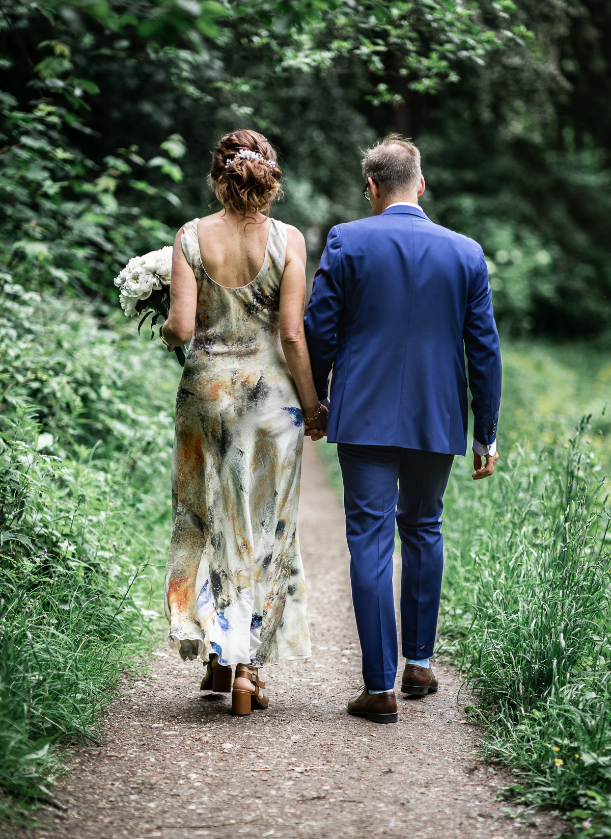 The bride and groom walking away.