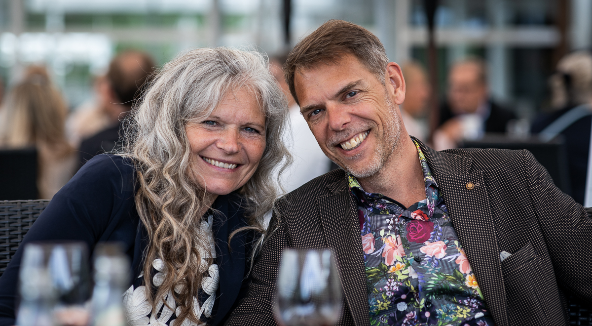 A woman and a man smiling.