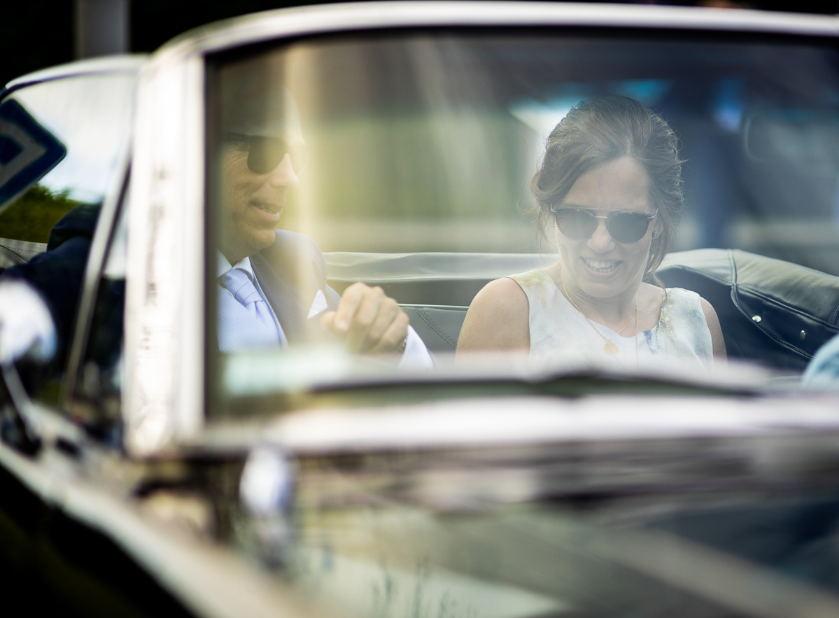 The bride and groom in a car.