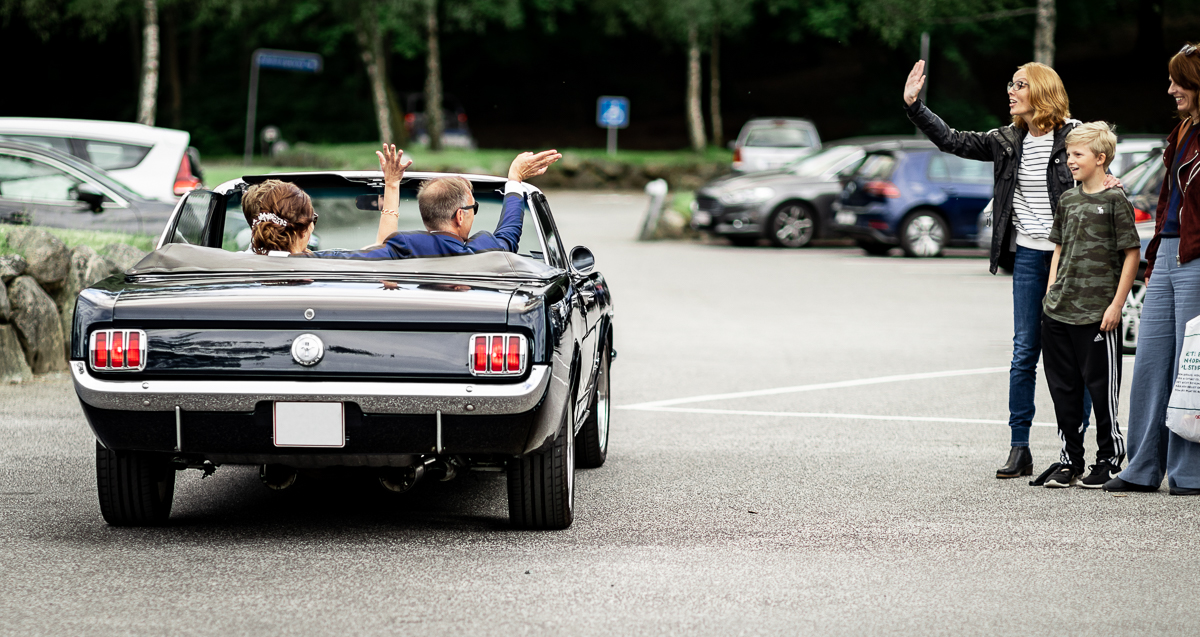 The bride and groom driving away.