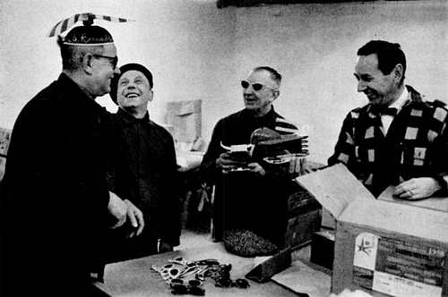 The propeller beanie drew laughs from Belgian workmen as they unpacked display shipments to show “How America Lives” for the U.S. exhibit at the Brussels Fair, as shown in Life magazine in 1958.
