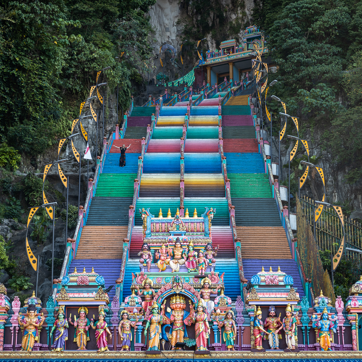 A woman standing on a colourful stairway.