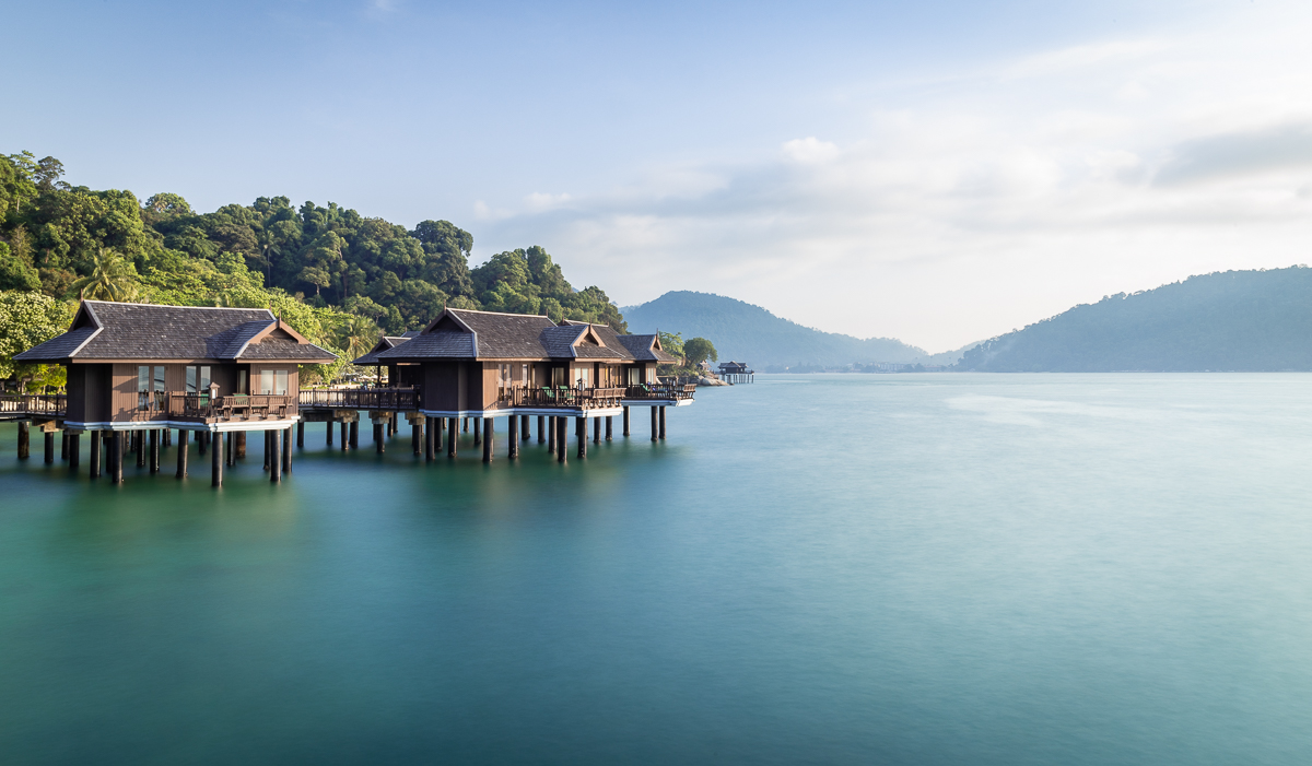 Multiple houses standing on top of water.